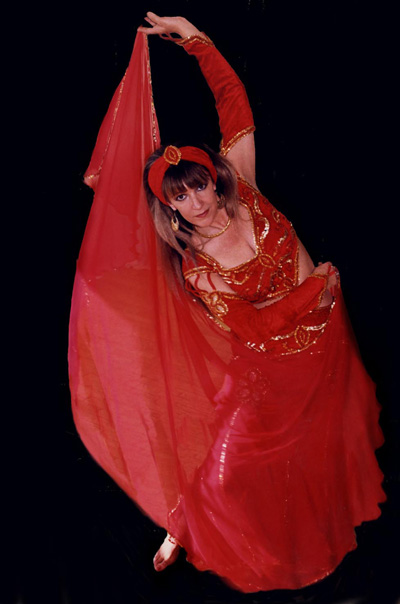 Josephine Wise in red costume ready to perform belly dance to the public